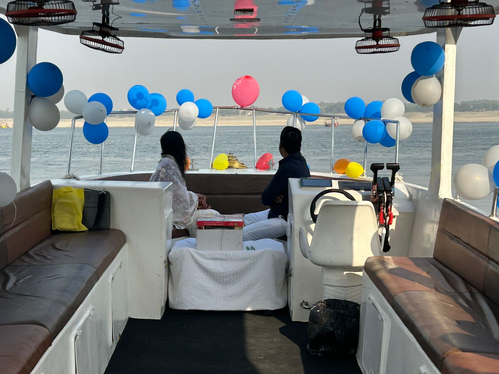 Enjoy a peaceful boat ride on the Ganga with beautiful balloon decorations